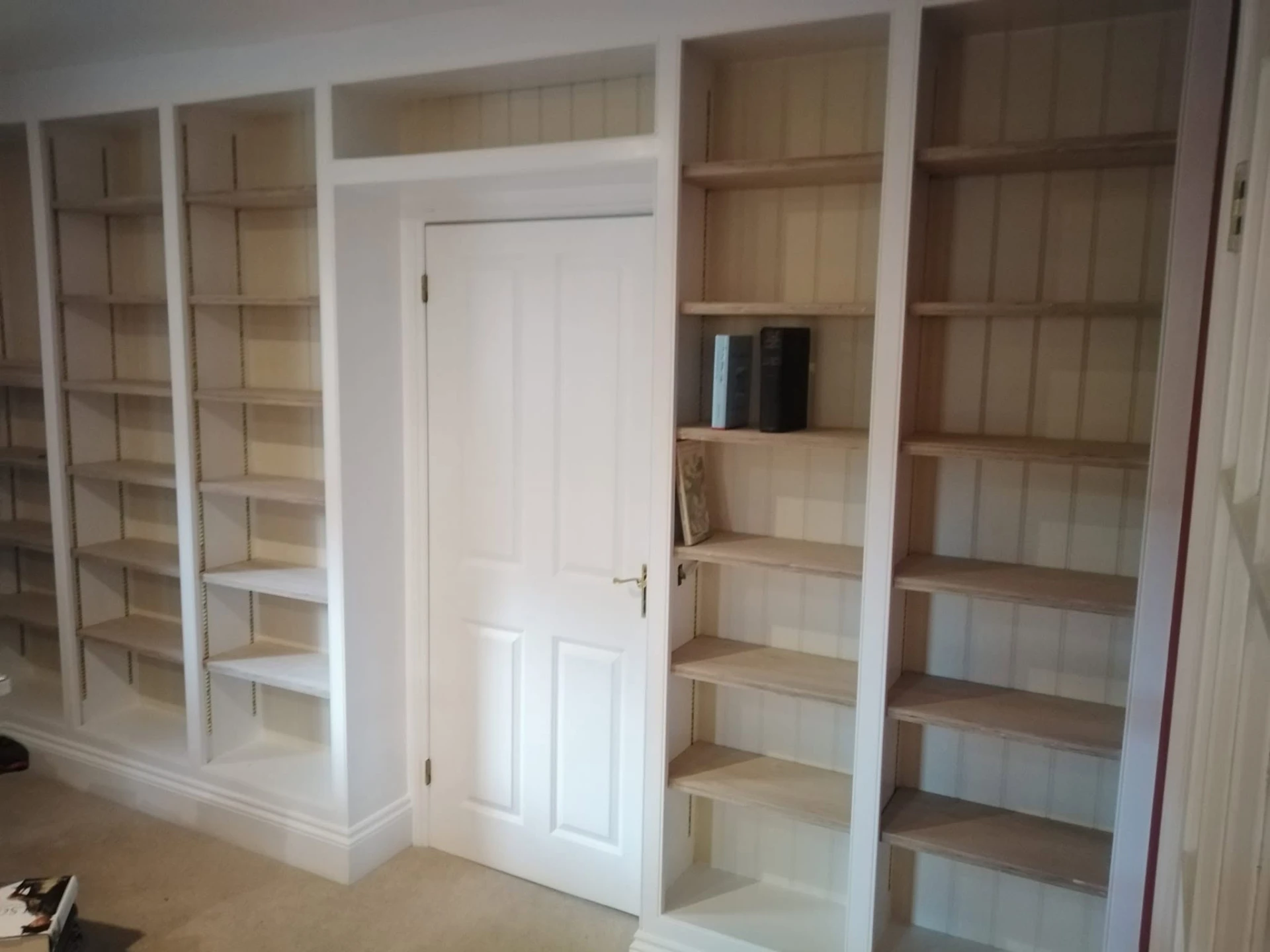 Floor to ceiling fitted bookcases around a doorway